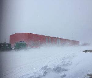 Blizzard at Casey Station showing Red Shed and Green Hagg blurred by snow