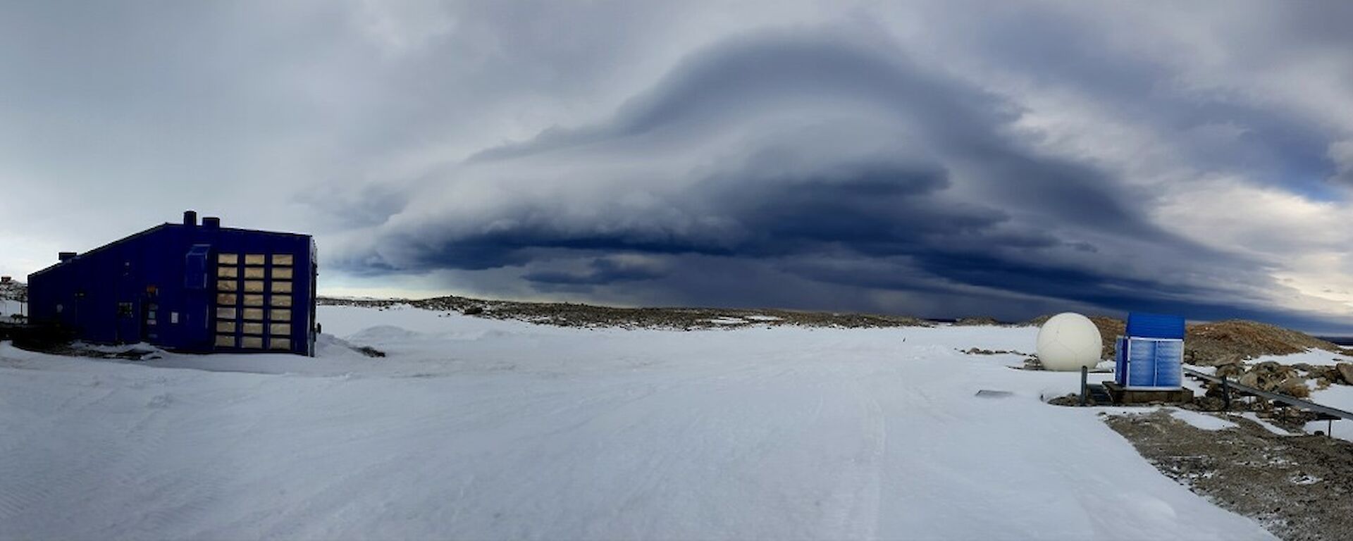 A wind storm brews in the distance before bringing a blizzard to Station