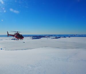 Helicopter flying home from the Totten Glacier with ocean and offshore islands in the distance