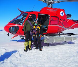 Juan and Maddie standing infront of the helicopter before heading out to the Totten Glacier