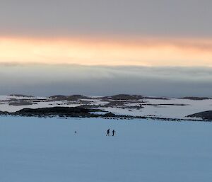 Casey sunrise with two expeditioners out for a morning ski in the recreation area