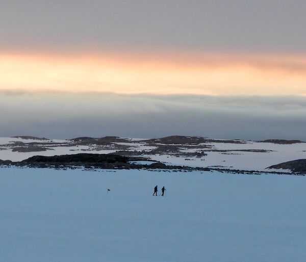 Casey sunrise with two expeditioners out for a morning ski in the recreation area