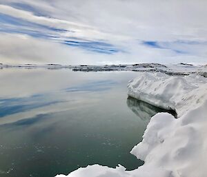 Casey Wharf — A perfect reflection looking out to Wilkes Station with water and the icy coastline