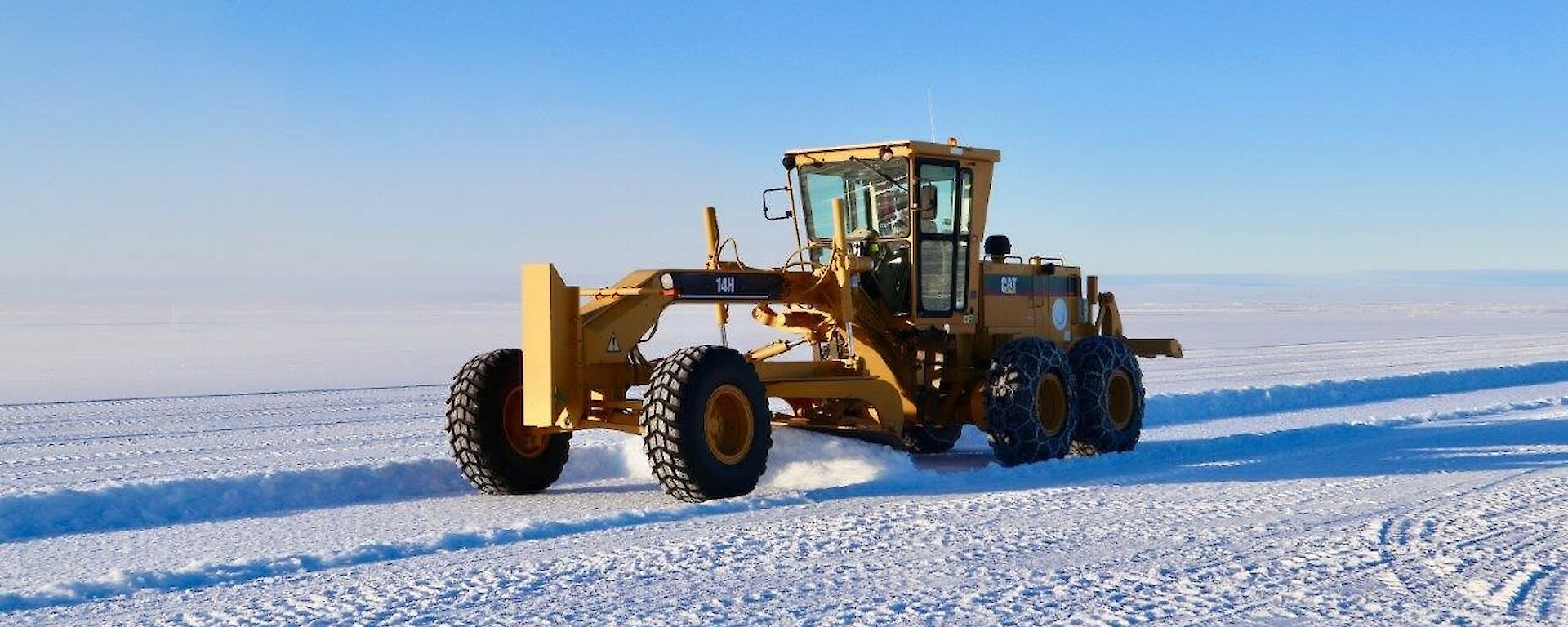 A grader on the ice runway in the construction phase