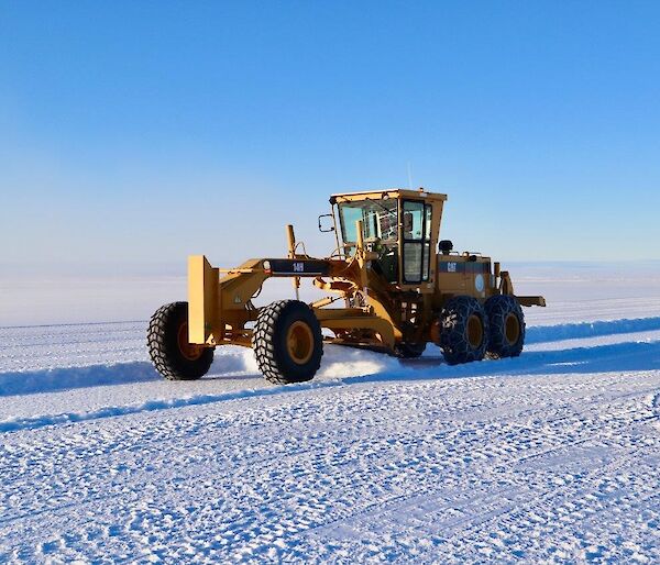 A grader on the ice runway in the construction phase