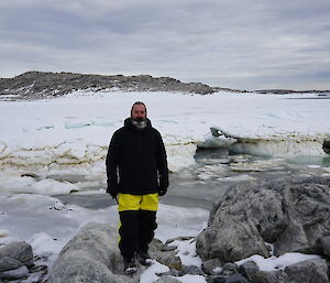 Simon standing near the shoreline with Obrien Bay behind him