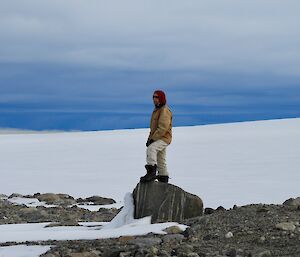 Rhys standing on a rock looking out in the distance