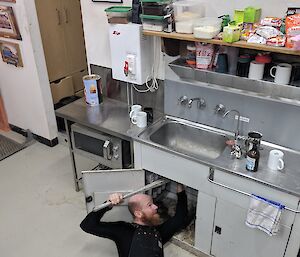 Garvan working on a sink laying on the ground