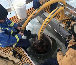 The team working on the melt bell looking down