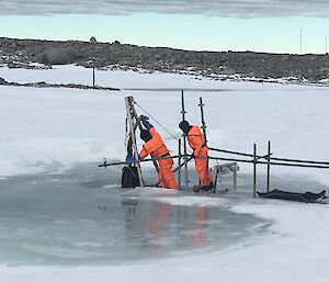 Peter H and Garvan working on the lake and the old pontoon and melt bell