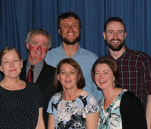 Casey’s Comms team in front of a blue curtain (L-R Robyne, Jason, Rachel, Mitch, Amanda & Brendan)