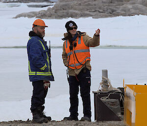 Amy talking to one of the tradies at the wharf with snow in the background