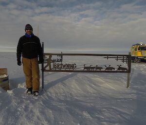 Fitzy standing next to the Browning’s sign with the yellow Hagg in the bckground