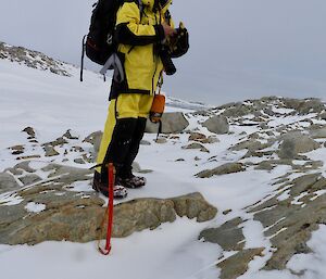 Conrad is his field gear on rocks and snow on survival training
