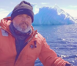 David on an iceberg cruise with an iceberg in the background