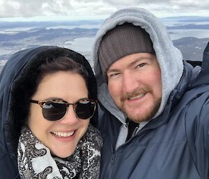 Selfie of Anna and Andrew on Mt Wellington with the Derwent River in the background