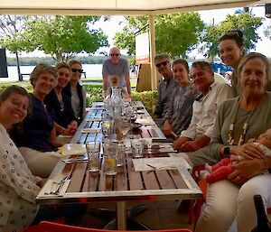 Part of Chris’s Noosa clan at a table with the river in the background