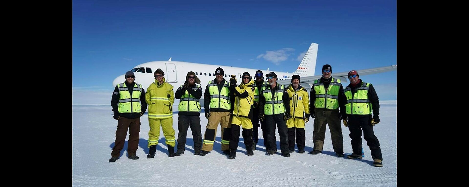 The wilkins team with Dr Karl and Kim Ellis the new director standing in front of the Airbus on the ice runway