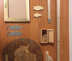 Crafts by Conrad displayed on a table including two ice axes, ear rings, frame and clock