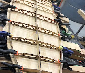 Franko’s surfboard with frame and bottom in clamps