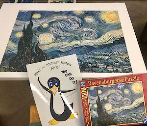 A Monet inspired puzzle completed with a sign saying you can do it with a penguin on it