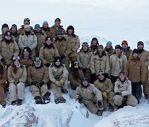 The 29 members of Casey on top of Reeve Hil with a snowy backgroundl