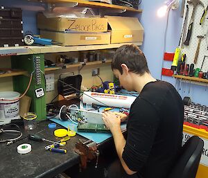 Sam sitting at his workbench