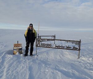 Sam standing at the Browning’s sign with snow all around