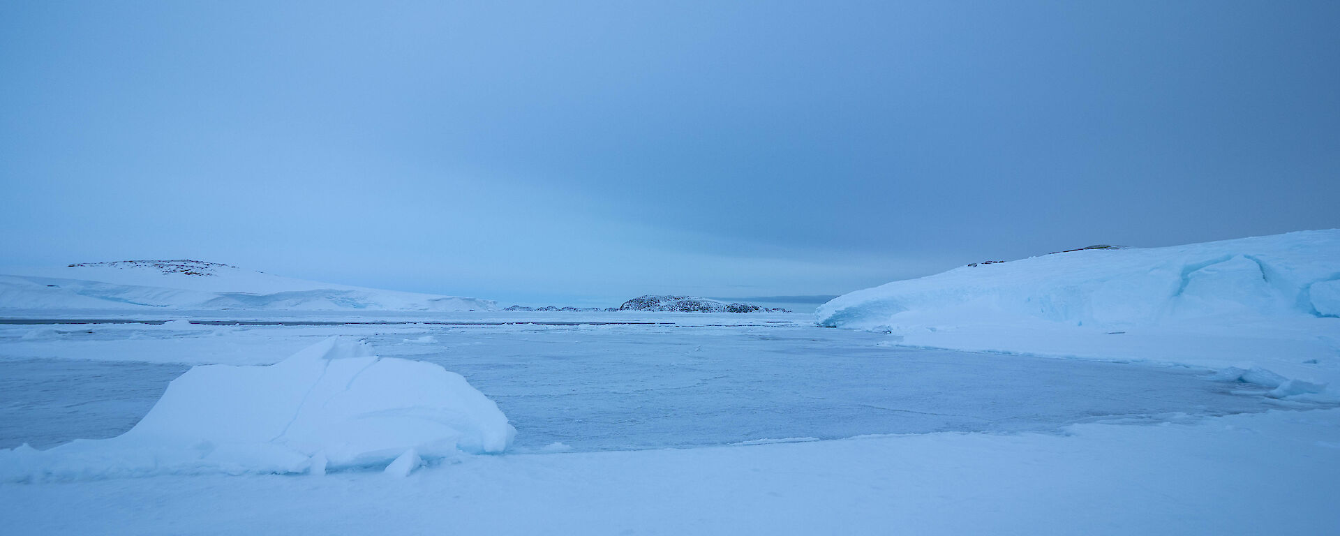 Carve out of the ice showing water along the cliff face