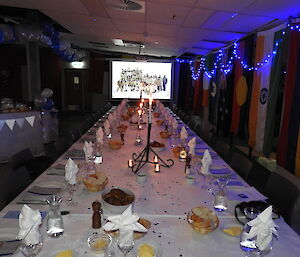 The formal table for dinner for 29 people decorated with blue lights