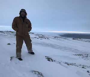 Scott standing on snow overlooking the Vanderford Glacier