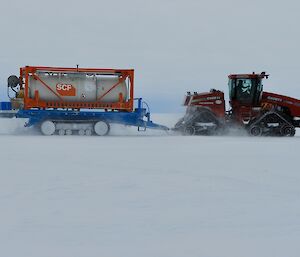 Case Quadtrack with a trailor on snow driving by
