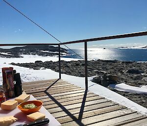 S cheese platter on the deck at Robbo’s with rocks and the bay in the background
