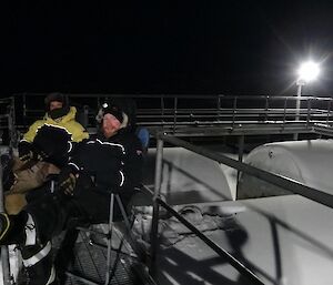 Garvan and Aaron sitting on the lower fuel tanks in deck chairs