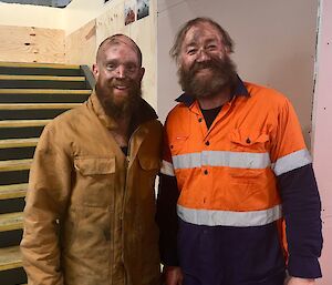 Garvan and Fitzy looking at the camera in the Red Shed with grim on their faces and body after spending a day cleaning the tank
