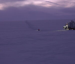 Hagg leading the way followed by the tractor and trailers up an incline to Law Dome