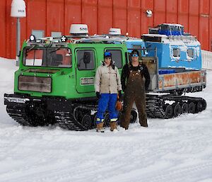 Ben and Josh standing in front of a green hagg with the blue hagg in the backdround in front of the Red Shed