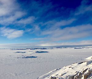 The snow and ice covered Newcomb Bay under a sunny sky