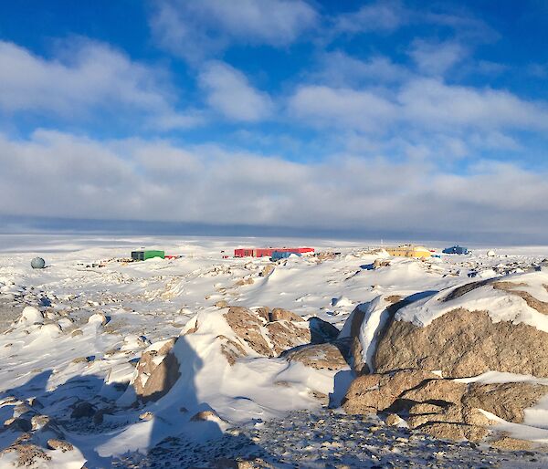 A sunny Casey with the Red Shed, Green Store, Yellow Science building surrounded by snow