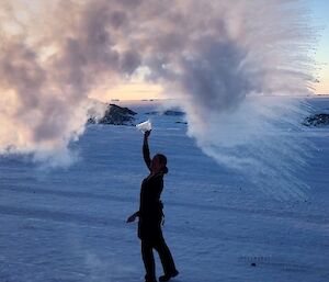 Jordan throwing water in the air and it freezes immediately over her head creating an ice cloud