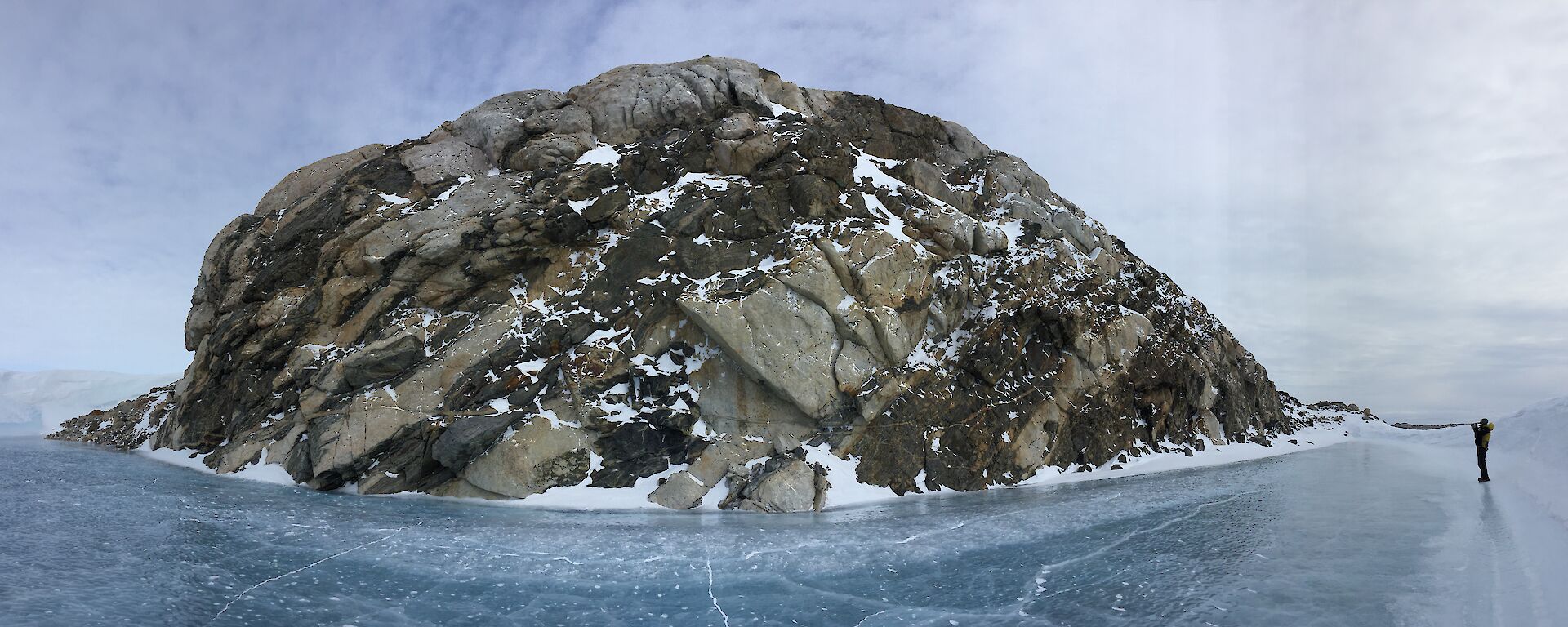 Panoramic of tiger rock and the blue ice that sourrounds it with Jordan shown taking a photo