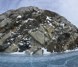 Panoramic of tiger rock and the blue ice that sourrounds it with Jordan shown taking a photo