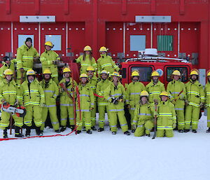 Casey’s Fire Team standing in front of and on the Fire Hagg in their fire gear