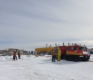 Fire team members using hoses from the red fire hagg to practice fire response techniques durig the handover of emergency response to the incoming 2019–2020 team