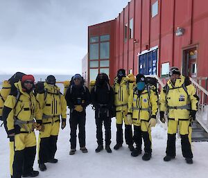 A group of expeditoners outside the red shed with their field gear ready to go on survival training