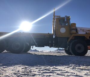 An arty shot of a truck with the sun as cargo on the back