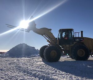 An arty photo of the forks appearing to carry the sun