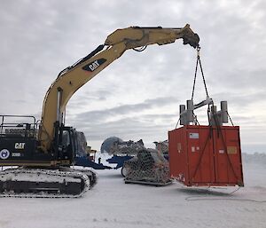 A crane moving a container around Casey with the cargo ready for the C17 in the background