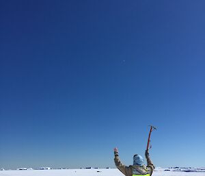 Dean A out on the sea ice near the Swain Group waving to the plane