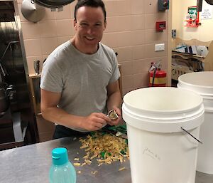 A man peeling potatoes in the kitchen at Casey